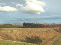 Fifty years ago this would have been an every day sight on the Highland Line, a passenger train headed by two Black Fives. 45231 and 45407 are pictured north of Tomatin with the <I>Great Britain II</I> on 10 April amid Highland scenery and sunshine. It's not often that the two go together!<br><br>[John Gray 10/04/2009]