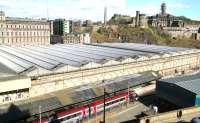 View over part of the vast glazed roof of Waverley from the North Bridge, looking towards Calton Hill on 7 April 2009, where scaffolding surrounds the Nelson Monument, currently undergoing major restoration. Standing at the old 'sub' platform 8 is the 1308 CrossCountry service to Plymouth preparing to start its journey south. <br><br>[John Furnevel 07/04/2009]