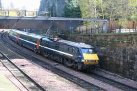 The 0700 Kings Cross - Glasgow Central NXEC service skirts the base of the Castle Rock shortly after leaving Waverley on 7 April on the last stage of its journey. The Scott Monument and NB Hotel can be seen in the left background. <br><br>[John Furnevel 07/04/2009]