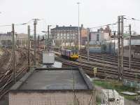 The northern approaches to Preston in the area of Fylde Junction. Northern Rail unit 142005 has drawn to a halt in a siding outside the power box, prior to reversing back into the station. The tracks merging in the left foreground are for Lancaster while those on the right are for Blackpool. The large building directly above the Pacer is County Hall, situated close to the station itself. <br><br>[Mark Bartlett 13/04/2009]