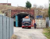 This is Newline tunnel, just south of Bacup, on the steeply graded line to Rochdale. Closed in 1947 the track remained for many years and the tunnel featured in a Hayley Mills scene in the film <I>Whistle down the Wind</I> as did the Lee Moor Bridge [See image 23306]. The tunnel has subsequently been turned into a vehicle workshop. <br><br>[Mark Bartlett 16/04/2009]