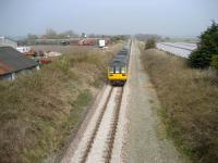 Looking north towards Rufford as an Ormskirk to Preston service makes its way across rural West Lancashire on 3 April 2009. Services on this route are normally single car Class 153s but, with the Grand National meeting at Aintree at the time, trains had been lengthened by the addition of a Class 142 unit. <br>
<br><br>[John McIntyre 3/04/2009]