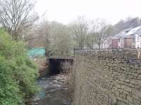 Space was always at a premium in the upper Rossendale Valley and Stacksteads station, last stop before the terminus at Bacup, was built over this bridge on the River Irwell. The grass mound is part of the remains of the island platform. Trains ceased to run beyond Rawtenstall in December 1966 and the track was lifted soon after.<br><br>[Mark Bartlett 16/04/2009]