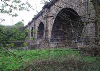 Viewed from the Lancaster to Wennington trackbed, John Rennie's Lune Aqueduct carries the Lancaster Canal across the River Lune on five arches, each spanning 70' and at least 50' above the river. This significant engineering achievement cost 48,000 in 1797, almost three times its original estimate, and is still open for canal traffic having outlived the railway by over 40 years already. Map Ref SD 485639. <br><br>[Mark Bartlett 24/04/2009]