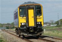 The one coach wonder 153363 forms the 1539 hrs from Preston to Ormskirk as it crosses Farington Moss and approaches Sod Hall occupation crossing on 25 April 2009.<br><br>[John McIntyre 25/04/2009]