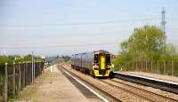 158 950 eastbound at Pilning station on 21 April 2009 having almost completed the ascent from the eastern portal of the Severn Tunnel. In the left background stand the uprights of the second Severn Crossing.<br><br>[Peter Todd 21/04/2009]