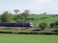 On 1st May 1939, four of the six stations between Preston and Lancaster closed. 70 years later to the day, 185116 speeds through Galgate on its way to Manchester Airport.  The station itself was situated some 200yds north of this point but is inaccessible  for pictures and in any case all trace has been swept away. View from the A6 main road immediately north of the M6 Junction 33 roundabout. <br><br>[Mark Bartlett 01/05/2009]