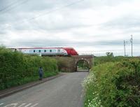 On the 70th anniversary of closure (1.5.39) a Voyager speeds north past the site of Scorton station. The station comprised wooden platforms elevated on the embankment immediately south of this small bridge over Station Lane [See image 23874]. All trace of the station was swept away many years ago.<br><br>[Mark Bartlett 01/05/2009]