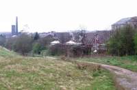 The highest point on the L&YR system was Britannia station, at 921', and this view looks north down the steep bank towards Bacup from the site of the station, closed in 1947 (Map Ref SD 884215). The Lee Moor Colliery tramway bridge [See image 23306] is situated just beyond the mill.<br><br>[Mark Bartlett 16/04/2009]