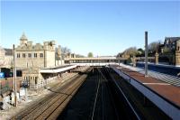 Looking north from the road bridge at Lancaster station on 12 April 2009. The covered walkway between the eastern and western parts of the station can be seen in this photograph. Platform 3 for northbound services is on the left and Platform 4 for souhbound services on the right. Platforms 1 & 2 are the north facing bays beyond the building on the left and platform 5 is a loop beyond the building on the right.<br><br>[John McIntyre 12/04/2009]