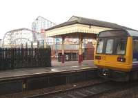 One of the more distinctive station backdrops! With <I>The Big One</I> standing 250 feet high in the background, Northern Pacer 142045 calls at Blackpool Pleasure Beach on a service from Colne. Even on a wet day like this, with the Pleasure Beach closed, this station is busier than the terminus at Blackpool South.<br><br>[Mark Bartlett 05/05/2009]