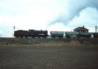With traces of snow on the Ochil Hills, J38 0-6-0 no 65921 heads west past Kincardine Junction signal box in the 1960s. The wagons are coal empties returning from Kincardine power station to the yards at Alloa. <br><br>[Robin Barbour Collection (Courtesy Bruce McCartney) //]