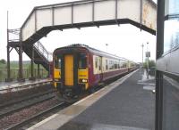 A 4-car mixed livery 156 combination pulls into Cleland on 6 May 2009 with a train on the Edinburgh - Glasgow Central via Shotts route.<br><br>[David Panton 06/05/2009]