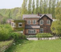 View west over the former station at Goldsborough (closed 1958), standing alongside the York - Harrogate line (seen running past on the left). Now converted to living accomodation, the building incorporates the former signal box, the lower section of which is now an integral garage.<br>
<br><br>[John Furnevel 24/04/2009]