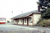 The remaining building on the Dumfries bound platform at Dalbeattie in September 1973 viewed looking towards Castle Douglas. The road then ended here but has now been driven through the site. The bus stands on the filled-in area between the former platforms.<br>
<br><br>[Colin Miller /09/1973]