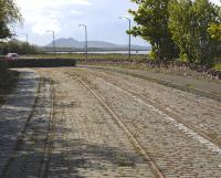 A little to the east of Prestongrange Industrial Museum is a long abandoned stretch of roadway containing tram tracks. This is part of the Portobello and Musselburgh Tramway extension to Port Seton, opened in 1909 and closed in 1928. View west in May 2009 with Arthur's Seat on the horizon.  <br><br>[Bill Roberton 10/05/2009]