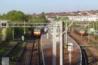 View east over Airdrie station towards Drumgelloch on 13 May 2009. 320313 has stopped at the through platform and 320308 stands in the siding.<br><br>[John Steven 13/05/2009]