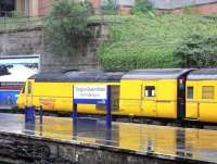 On a wet 5 May 2009, Network Rail's NMT brings a splash of sunshine yellow to Glasgow Queen Street.<br><br>[David Panton 05/05/2009]