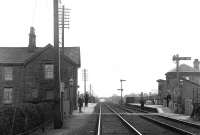 Pre-1918 picture of the Lancaster & Preston Junction Railway station opened in 1849 at Brock on the WCML, looking south towards Preston. The picture is full of period detail, including lower quadrant signals, a wooden bodied wagon in the siding and early staff uniforms. The milk churns are probably empties awaiting return to local farmers. Brock station closed to passengers in 1939 and, with the exception of the foot crossing [see image 23510], nothing in this picture survived the 1972 electrification. <br>
[Railscot note: Reverend Ron Greenall is a local historian and railway enthusiast in the Garstang, Lancs, area. Over the years many people have sent Ron old pictures for use in his weekly local newspaper feature and he has kindly agreed, via Mark Bartlett, to�share some of his collection of railway photographs with the Railscot website.]�<br>
<br><br>[Rev Ron Greenall Collection //]