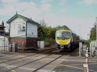 Between Blackpool and Poulton, just east of Layton station, is the block post signal box at Carleton, which also covers a very busy level crossing. The signals at Carleton Crossing are still semaphores, one of which can just be seen alongside 185129 working a Transpennine Blackpool North to Manchester Airport service.<br><br>[Mark Bartlett 12/05/2009]