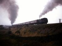 Completed in 1846, the Lancaster and Carlisle Railway over Shap stands as perhaps the greatest tribute to engineer Joseph Locke.   The photograph, taken in the 1960s, shows a 2-6-4T working hard on banking duty north of Scout Green near the Shap Wells Hotel.<br><br>[Robin Barbour Collection (Courtesy Bruce McCartney) //]