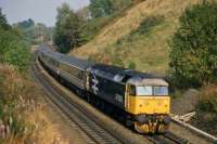 During the 1980s, there were two named daytime through trains between Inverness and London, the Highland Chieftan (Kings Cross) and the Clansman (Euston). The up Clansman is shown here passing through the Laighills in Dunblane behind 47 630 in September 1986. It is identifiable by the red carriage stripe (then blue for ScotRail stock). Whereas the Chieftan called at Edinburgh and needed no change of loco north of the border, the Clansman had to bypass Glasgow and change haulage for the WCML. From 1987, the Clansman was diverted via Edinburgh, with the result that it took over 90 minutes longer to reach London than its rival. It was eventually withdrawn as a through service in 1992.<br><br>[Mark Dufton /09/1986]