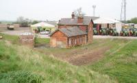 The remains of Sinderby station (1852), North Yorkshire, on the former  Northallerton - Leeds via Harrogate line, photographed on 24 April 2009 looking north. The station closed to passengers in 1962, with the line itself closing completely 5 years later. The land in the immediate vicinity of the old station is now occupied by an agricultural equipment supplier. The  A1 road runs past the site directly behind the camera. Note the preserved class 47 standing in the left background. [See image 23755] <br>
<br><br>[John Furnevel 24/04/2009]