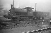 Busy scene at St Margarets shed in the autumn of 1958 with class Y9 0-4-0ST no 68097, complete with wooden tender, moving slowly through the yard. The smoky atmosphere seems to have blotted out the tenements on London Road almost completely on this occasion.<br>
<br><br>[Robin Barbour Collection (Courtesy Bruce McCartney) 06/09/1958]