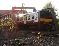 320318 comes out of the sun as it crosses the bridge over the A89 east of Coatdyke station on 20 May 2009 with an evening service for Airdrie.<br>
<br><br>[John Steven 20/05/2009]