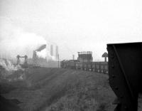 On the roof of County Durham in 1960. Tyne Dock 9F 2-10-0 no 92097, having completed the climb up from the coast, is about to take its train of iron-ore hoppers through the automated discharge area at Consett. The good news for the fireman is that the road home is all downhill!<br>
<br><br>[K A Gray 26/03/1960]