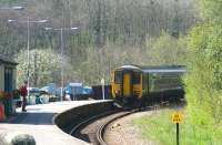 A lone hiker breathes a sigh of relief as a late running <I>Esk Valley Line</I> service rounds the curve into Grosmont station's platform 1 in April 2009. The train from Middlesbrough is 20 minutes and 3 stops from its ultimate destination at Whitby.<br><br>[John Furnevel 20/04/2009]