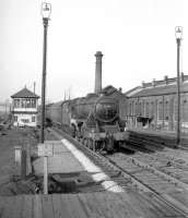 Stanier Black 5 no 45399 approaching Hellifield from the north in the 1960s, passing the former 4-road Hellifield shed, closed by BR in 1963. The building was later partially renovated and put to use for a number of years as a base for the storage and preparation of locomotives and other exhibits bound for the planned National Railway Museum in York, which opened in 1975. The old shed was eventually demolished in 1990. Locomotive 45399 was withdrawn from Carnforth at the end of 1966 and cut up at Drapers of Hull some 6 months later. <br>
<br><br>[Robin Barbour Collection (Courtesy Bruce McCartney) //]