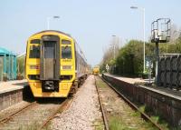 View from Bridlington Road level crossing as a Northern 158 pulls away from Hunmanby with the 0941 Sheffield - Scarborough service on 21 April. Standing on the up line just beyond the platforms is a Network Rail weedkilling train, which should find plenty to keep it occupied along this section.<br>
<br><br>[John Furnevel 21/04/2009]