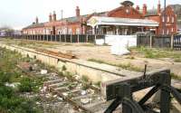 View south west towards Bridlington station over the abandoned excursion platforms 7 & 8 on 23 April 2009.  A Northern 158 service to Sheffield is in the left background standing in bay platform 6. Through platforms 4 & 5 are still used by trains on the line north to Scarborough, while the former platforms 1-3 are now covered by a housing development on the far side of the station.<br><br>[John Furnevel 23/04/2009]