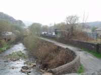 The site of Waterfoot station, alongside the River Irwell, viewed from the west portals of  Newchurch No. 1 and Thrutch tunnels looking towards Rawtenstall. An industrial yard occupies the site of the station, closed with the line in 1966.<br><br>[Mark Bartlett 16/04/2009]