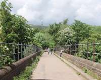 A view over Tottington viaduct, along the Holcombe Brook branch (Kirklees trail), towards Greenmount and the terminus. The local landmark, Peel Tower, can be seen high on Holcombe Moor. <br><br>[Mark Bartlett 26/05/2009]