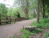 Tottington station is the only one on the former Holcombe Brook branch to retain significant remnants.  In this view towards the terminus the concrete platform face can still be seen as, in the foreground, can an overhead catenary mast base last used around 1918.<br><br>[Mark Bartlett 26/05/2009]