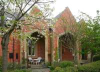 Once served by long distance trains, Ripon station closed to passengers in March 1967. The impressive 1848 building, the entrance to which is said to echo the classic lines of Ripon Cathedral, has since been converted to residential accomodation, seen here on 24 April 2009. A powerful lobby continues to press for re-establisment of train services to Ripon utilising much of the former 12 mile link from Harrogate, though any future station would be located further south nearer the town centre on the other side of the River Ure.<br>
<br><br>[John Furnevel 24/04/2009]