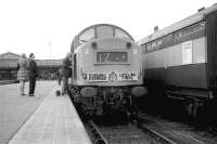 EE Type 4 no 263 waits at the north end of platform 6, Aberdeen with the 'Evening Express Lifeline Final' to Kyle of Lochalsh on 23 April 1973. The ex LNER coach on the right with Gresley bogies was part of an exhibition train, the sign reads 'rea mobile marketing'.<br><br>[John McIntyre 23/04/1973]