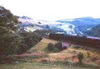 Standard and Black 5 locomotives double head a southbound train through Drumlanrig Gorge in the 1960s.<br><br>[Robin Barbour Collection (Courtesy Bruce McCartney) //]