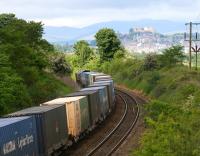 A northbound DRS class 66 rounds the curves near Cowie on 28 May 2009 hauling the Grangemouth - Aberdeen containers. Stirling Castle dominates the background - with a definite touch of 'Walt Disney' about it...<br><br>[John Furnevel 28/05/2009]