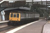A Pressed Steel Class 117 suburban DMU leaves the Up slow line platform at Taplow heading for Paddington in 1981. When these 1st generation units were eventually replaced by Thames Turbo units some of them were cascaded to Haymarket and, in the 1990s, were among the last early DMUs in service.<br><br>[Mark Bartlett 18/07/1981]