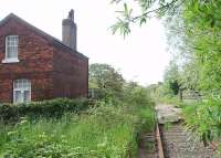 The Fleetwood line slumbers on, ten years after the last goods train ran. This is School Road crossing, just south of Thornton Cleveleys station looking towards Poulton, showing the former crossing keeper's cottage.  <br><br>[Mark Bartlett 29/05/2009]