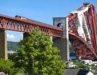 View from the north shore on 1 June 2009 with EWS 67025 about to leave The Forth Bridge and run into North Queensferry station with the evening locomotive-hauled Fife Circle service.<br><br>[Bill Roberton 01/06/2009]