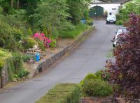 View over the site of Rumbling Bridge station, looking towards Dollar, in June 2009. The goods yard, main station building, northbound platform etc have all been replaced by a housing estate off to the right. The old southbound platform is now part of a landscaped area alongside the access road.<br><br>[Brian Forbes /06/2009]