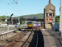 <I>You could hear the squeal all over Carnforth.</I> Pacer 144001 joins the sharp curve to take it back over the main line and on towards Wennington. These four wheeled units can be heard protesting every time they negotiate this piece of track. The original stone built signal box still stands on the platform with the operational cabin beyond and West Coast Railways depot on the opposite side of the line.<br><br>[Mark Bartlett 30/05/2009]