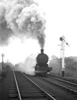 A train of steel flats climbs through Beamish towards Consett in February 1964 behind Q6 0-8-0 no 63455. Tyne Dock shed's allocation around this time included 16 of the hard working and reliable Q6s as well as 10 of the Westinghouse pump - fitted 9F 2-10-0s.<br><br>[Robin Barbour Collection (Courtesy Bruce McCartney) 15/02/1964]