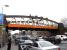 View along Great Western Road at Anniesland station on 1 April 2009, showing what is probably the most prominent overbridge still to have the image before last still in place.<br><br>[David Panton 01/04/2009]