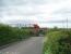 On the 70th anniversary of closure (1.5.39) a Voyager speeds north past the site of Scorton station. The station comprised wooden platforms elevated on the embankment immediately south of this small bridge over Station Lane [See image 23874]. All trace of the station was swept away many years ago.<br><br>[Mark Bartlett 01/05/2009]