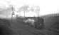 Not the ideal time for quiet contemplation amongst the good people of Annfield Plain, as a pair of Tyne Dock's finest wrestles 700 tons of iron ore onwards and upwards past Annfield East box on the final leg of the climb towards Consett steel works in February 1964. 92066 is the train locomotive on this occasion with 92063 banking.<br><br>[K A Gray 15/02/1964]